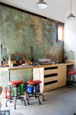 Here is a peek into our jewelry-making studio. This is a beautiful old wall from the original building. Firing station, tumblers, oxidizing.