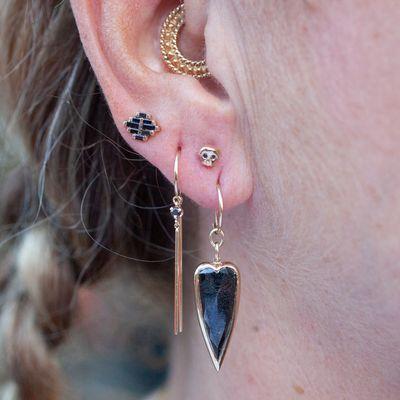 Black diamond ear piercing styling with a Black Diamond Punk Heart charm, Black Diamond Eyed Skully, Long Diamond Chime, Arcadia Stud.