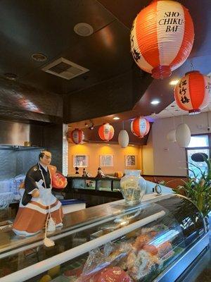 Male Japanese doll and paper lanterns inside the restaurant