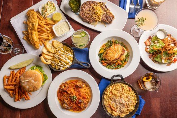 Chilean Seabass and Ribeye steak with cocktails, a burger, Fish n Chips, and Lobster Mac n Cheese. Perfect for a group of friends and family