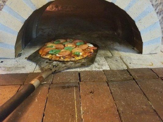 Our handcrafted wood fired brick pizza oven.