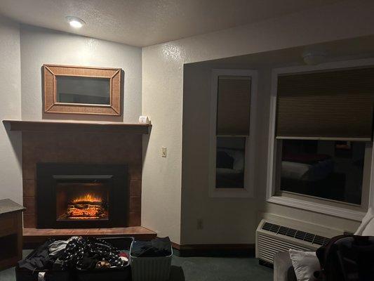 Fireplace, recessed lighting, great bay window with HVAC unit.