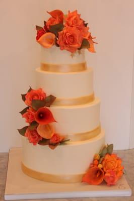 27 inch tall buttercream cake with gorgeous sugar flowers to match the fall season.