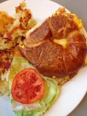 Breakfast croissant sandwich with hash browns