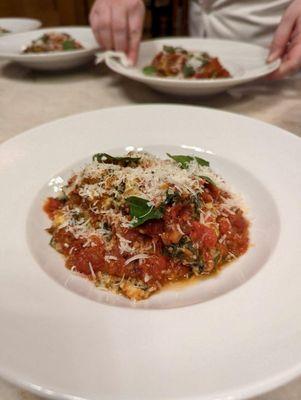 Malfatti w. Lamb Pomodoro Sauce, Parmigiano Reggiano, and basil.