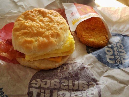 Bacon, egg, and cheese biscuit with a hash brown