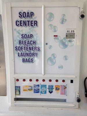 Soap machine that sells detergent, liquid fabric softener, fabric dryer sheets, and bags.