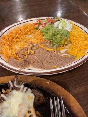 A plate of rice and beans that comes with the fajitas I ordered YUMMY