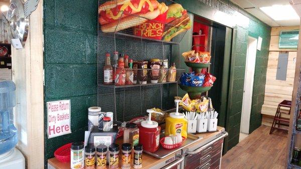 Condiment area with interesting flavored salts and lots of hot sauce