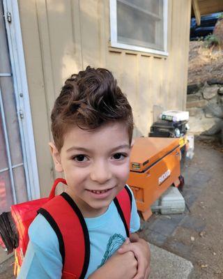 Excited to go to school, loved his new hair. He got a lot of compliments. The curl/waves are visible, but now his happy face is visible too.