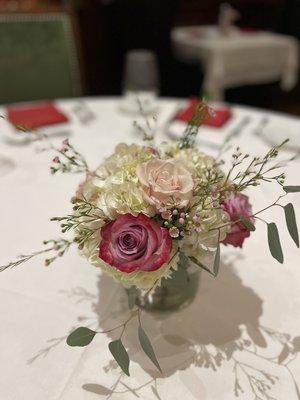 Wedding centerpiece in short cylinder vase (roses, wax flowers, hydrangeas)