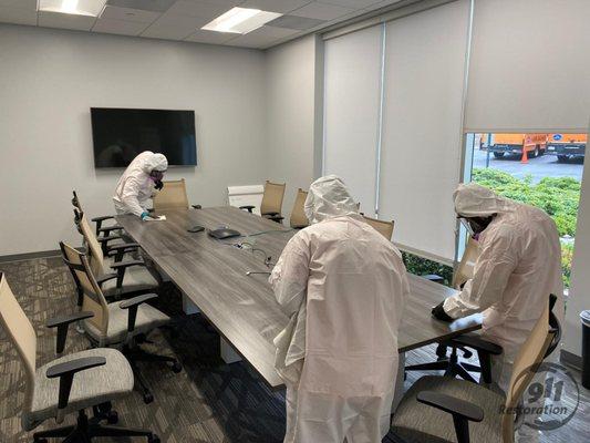 Three Guys Cleaning Conference Room