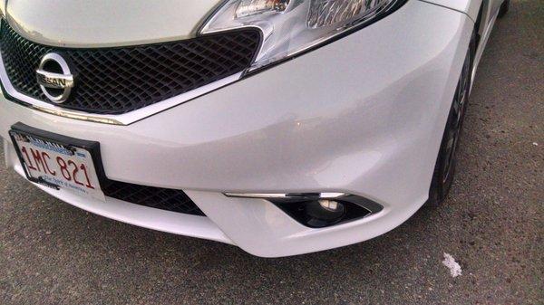 This bumper was scratched, dented and a part replaced. Looks like new.