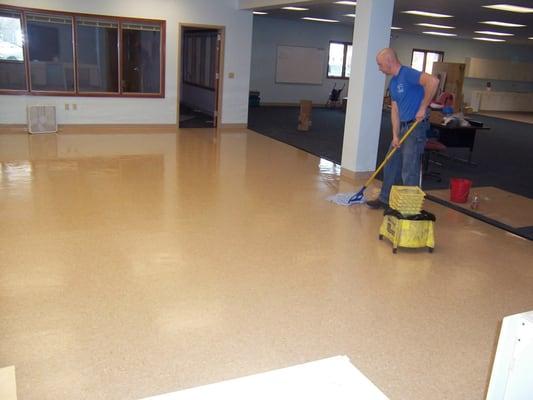 Tech applying wax to a school floor.  our normal process is to apply 5 coats.