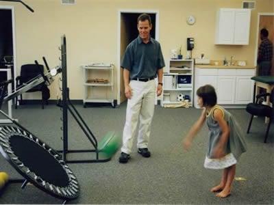 PTA Paul Toran working with a patient in our gym