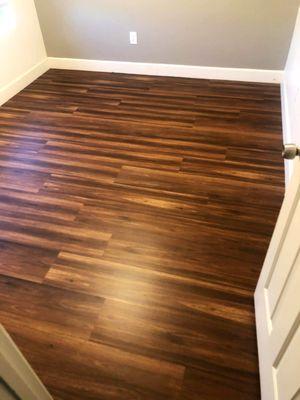 This beautifully installed dark wood LVP flooring showcases the quality craftsmanship of Straight Edge Flooring...