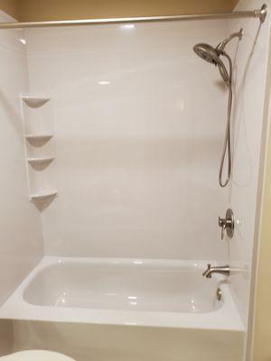 Shower/Tub completed with white marble and brushed nickel