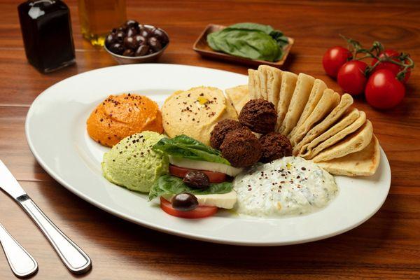 Appetizer Combo: Garbanzo, spicy, and edamame hummus, caprese, tzatziki, and falafels made to order.