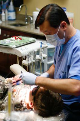 Dr. Chris Truong happy to tell Mr. Kaden that he is cavity free!