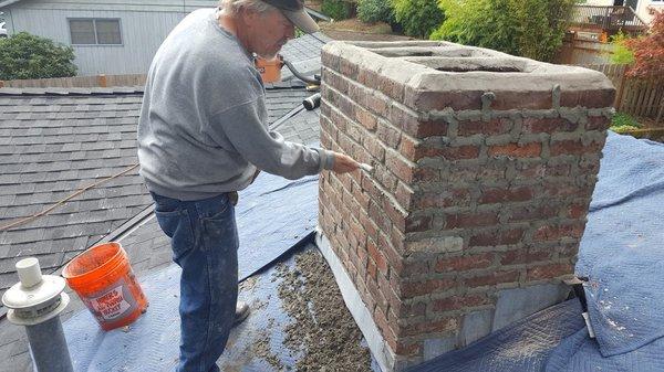 New mortar joints being tooled smooth.