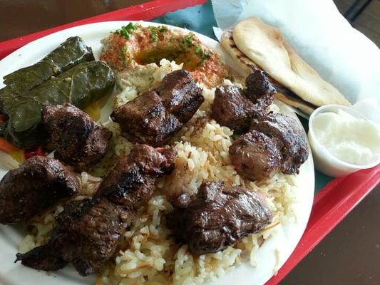 Beef kabab plate, w/ grape leaves, baba ghanouj, rice, garlic sauce & pita bread