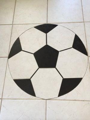 Porcelain tile and granite soccerball on floor