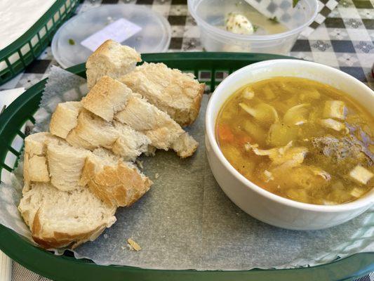 A cup of Italian wedding soup and bread