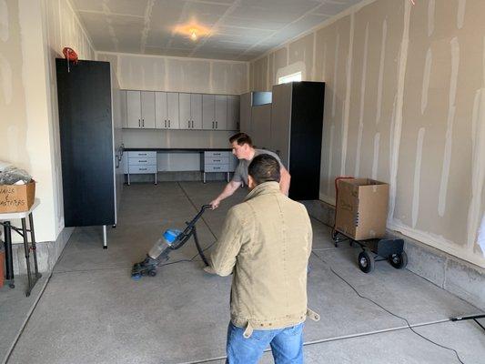 Classy Closets crew vacuuming up the saw dust upon completion of their installation.