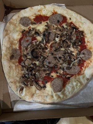 Medium Sausage and mushroom with extra cheese, half baked.