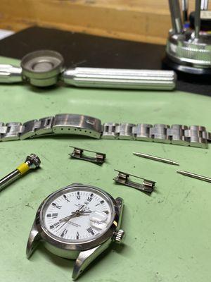 Final touches on a Rolex Date in for service