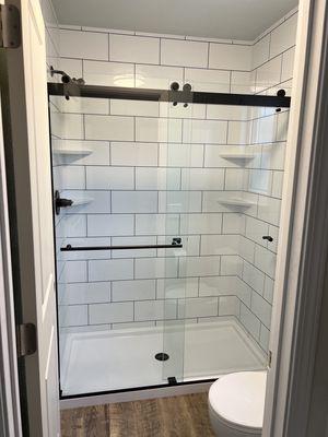 Easy maintenance shower door. The white tile with dark grout is on point!