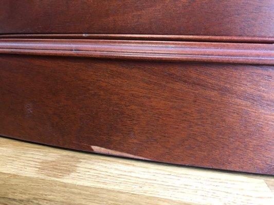 They chipped a piece of the veneer off a hundred year old restored buffet.