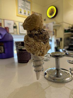 Pumpkin pie and salted caramel brownie scoop on a Rice Krispies treat cone