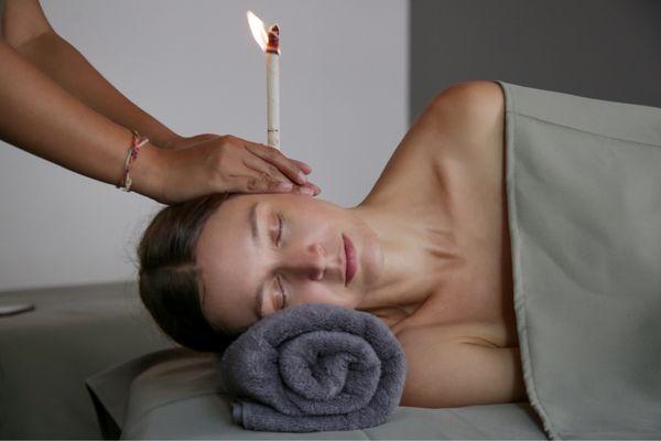 Client receiving an Ear Candleling session