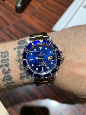 Pre-owned Rolex Submariner in stainless and 18k gold.