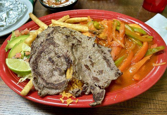 Mar y Tierra - large shrimps and beef meat served with rice, fries and salad.