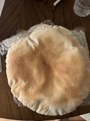 Pita bread not wrapped in anything, just thrown in the to go plastic bag.