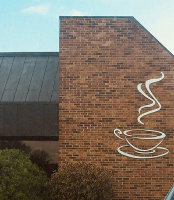 Cute coffee décor on the exterior of the building