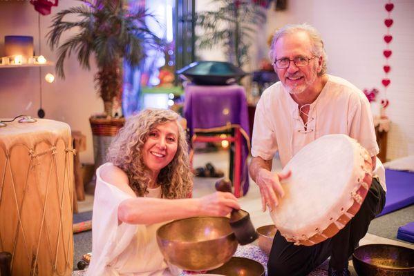 Dr. Gigi Turner playing a Tibeetan singing bowl and Dave Patrick on drums during a sound bath in Colorado Springs, CO