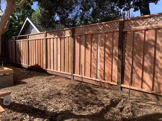 Red wood fence with privacy lattice, using 4x6 pressure treated posts.