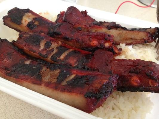 Roasted then flame broiled ribs with white rice.