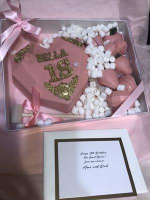 The breakable heart, bed of marshmallows, mallet with bow, chocolate covered strawberries, and a beautiful personalized note