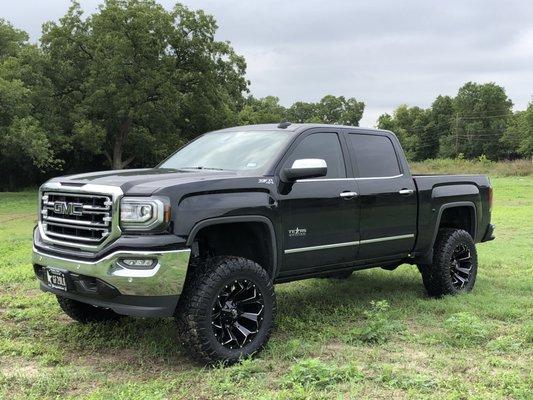 2018 GMC 1500 with a Rough Country 7" Lift Kit, Fuel 20x10 Wheels wrapped in 35" Toyo MT tires.