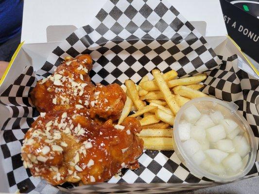 Chicken thighs with Korean sweet & spicy sauce and topped with almonds.