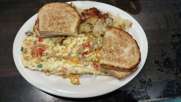 Veggie omelette, home fries, and sourdough toast