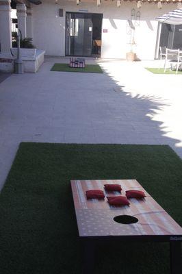 2024 Corn Hole Game in courtyard area.