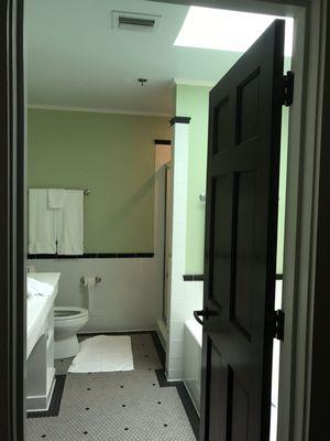 Spacious bathroom in my room with spa tub, skylight and separate shower.