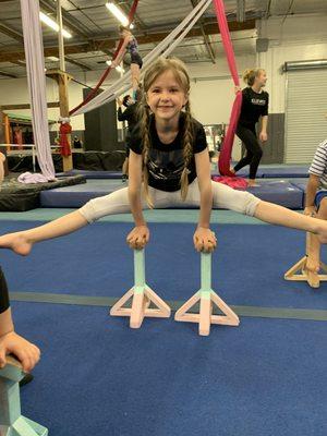 Holding a straddle on blocks.