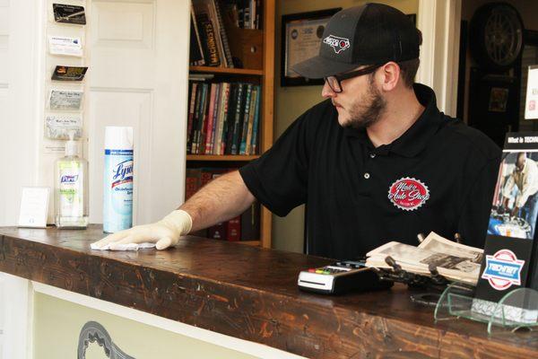 Our service manager keeping commonly touched surfaces wiped down (this pic is from early in the pandemic, masks are required now.)