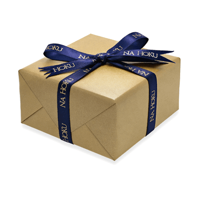 golden gift wrapped box and blue ribbon with golden Na Hoku print